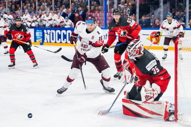 RIGA, LATVIA MAY 27 Rodrigo Abols of Latvia L against goalkeeper Samuel Montembeault of Canada R into the slot during the 2023 IIHF Ice Hockey World Championship Finland Latvia game between Canada and Latvia at Nokia Arena on May 27, 2023 in Tampere, Finland Tampere Finland  Copyright: xJustPictures.ch JarixPestelaccix