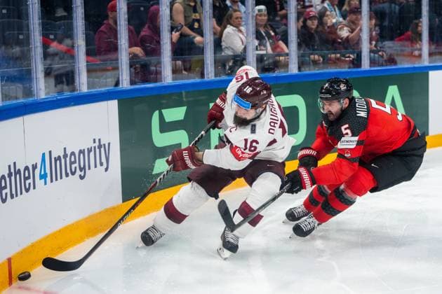RIGA, LATVIA MAY 27 Kaspars Daugavins of Latvia L against Jacob Middleton of Canada R during the 2023 IIHF Ice Hockey World Championship Finland Latvia game between Canada and Latvia at Nokia Arena on May 27, 2023 in Tampere, Finland Tampere Finland  Copyright: xJustPictures.ch JarixPestelaccix