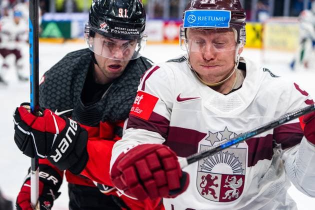 RIGA, LATVIA MAY 27 Adam Fantilli of Canada L against Ronalds Kenins of Latvia R during the 2023 IIHF Ice Hockey World Championship Finland Latvia game between Canada and Latvia at Nokia Arena on May 27, 2023 in Tampere, Finland Tampere Finland  Copyright: xJustPictures.ch JarixPestelaccix