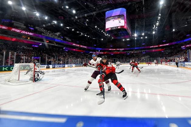 RIGA, LATVIA MAY 27 Jake Neighbours of Canada in a battle for the puck with Ralfs Freibergs of Latvia during the 2023 IIHF Ice Hockey World Championship Finland Latvia game between Canada and Latvia at Nokia Arena on May 27, 2023 in Tampere, Finland Tampere Finland  Copyright: xJustPictures.ch AndreaxBrancax