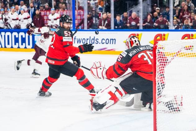 RIGA, LATVIA MAY 27 MacKenzie Weegar of Canada L deflect a shot in front of goalkeeper Samuel Montembeault of Canada R during the 2023 IIHF Ice Hockey World Championship Finland Latvia game between Canada and Latvia at Nokia Arena on May 27, 2023 in Tampere, Finland Tampere Finland  Copyright: xJustPictures.ch JarixPestelaccix