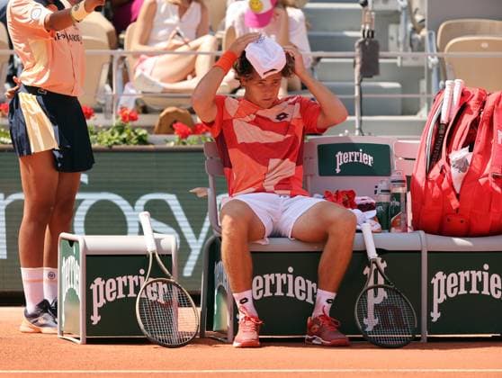 Aleksandar Kovacevic of the US flips his cap as he takes a break during his first-round match against Serbian Novak Djokovic at Roland Garros French Tennis Open in Paris, France, on Monday, May 29, 2023. Djokovic won 6-3, 6-2, 7-6.  PAR20230529522 MAYAxVIDON-WHITE