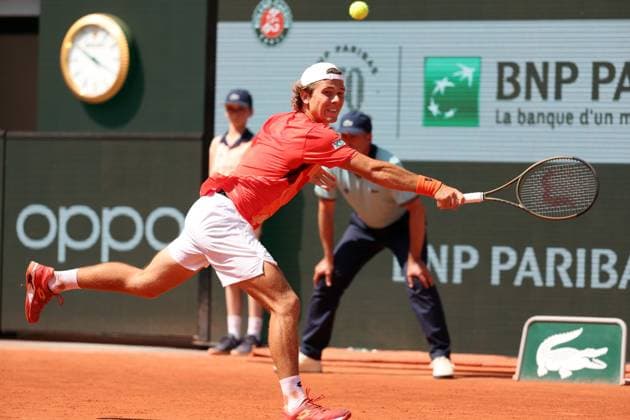 Aleksandar Kovacevic of the US returns the ball to Serbian Novak Djokovic during their first-round match at Roland Garros French Tennis Open in Paris, France, on Monday, May 29, 2023. Djokovic won 6-3, 6-2, 7-6.  PAR20230529528 MAYAxVIDON-WHITE