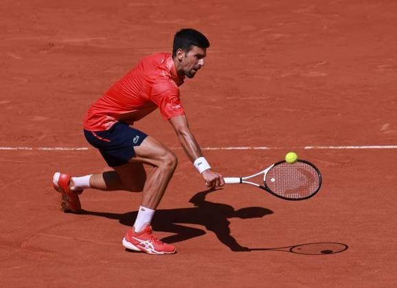 (230530) -- PARIS, May 30, 2023 -- Novak Djokovic of Serbia returns the ball during the men s singles first round match between Novak Djokovic of Serbia and Aleksandar Kovacevic of the United States at the French Open tennis tournament at Roland Garros in Paris, France, on May 29, 2023. ) (SP)FRANCE-PARIS-TENNIS-ROLAND GARROS-FRENCH OPEN-MEN S SINGLES GaoxJing 