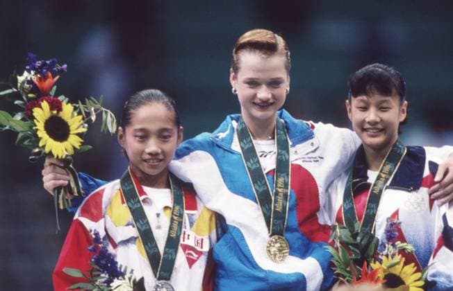 Atlanta, Georgia State, United States. US gymnast Amy Chow (second place), Russian gymnast Svetlana Khorkina (first place) and Chinese gymnast Bi Wenjing (third place) (L-R) participate in the award ceremony of the individiual uneven bars competition during the 1996 Summer Olympics at the Georgia Dome. Robert Maximov TASS  59521354