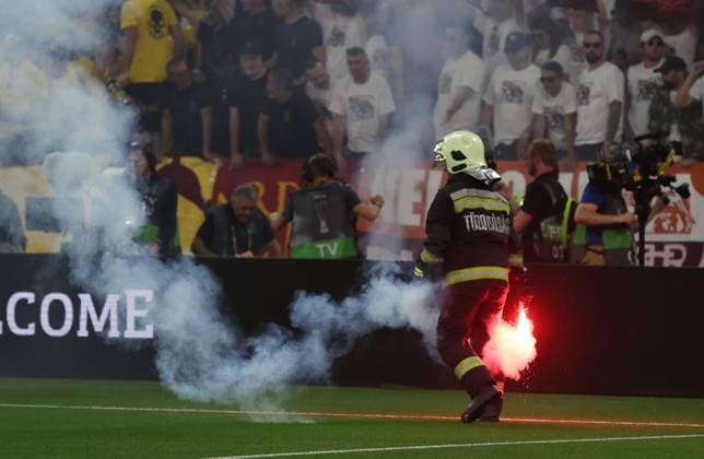 Budapest, Hungary, 31st May 2023. A fire steward removes a flare from the pitch during the UEFA Europa League Final match at Puskas Arena, Budapest. Picture credit should read: David Klein Sportimage EDITORIAL USE ONLY. No use with unauthorised audio, video, data, fixture lists, club league logos or live services. Online in-match use limited to 120 images, no video emulation. No use in betting, games or single club league player publications. SPI-2471-0040
