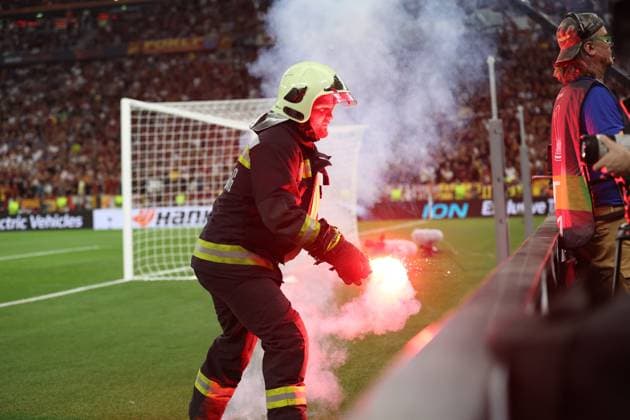 Budapest, Hungary, 31st May 2023. A fireman removes a flare from the pitch during the UEFA Europa League Final match at Puskas Arena, Budapest. Picture credit should read: David Klein Sportimage EDITORIAL USE ONLY. No use with unauthorised audio, video, data, fixture lists, club league logos or live services. Online in-match use limited to 120 images, no video emulation. No use in betting, games or single club league player publications. SPI-2471-0044