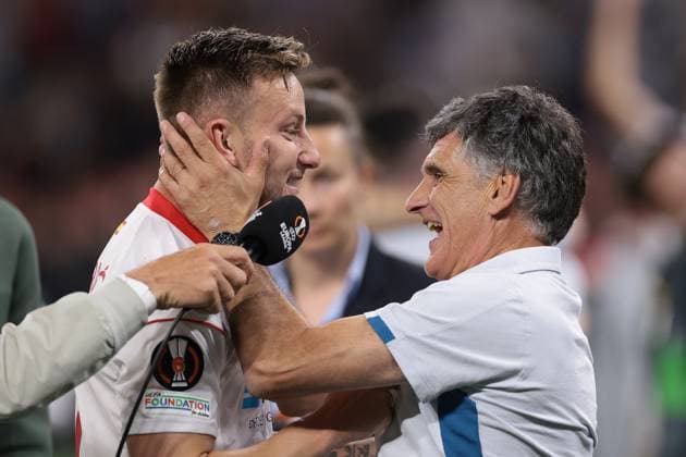 Budapest, Hungary, 31st May 2023. Jose Luis Mendilibar Head coach of Sevilla and Ivan Rakitic of Sevilla celebrate following the penalty shoot out victory in the UEFA Europa League match at Puskas Arena, Budapest. Picture credit should read: Jonathan Moscrop Sportimage EDITORIAL USE ONLY. No use with unauthorised audio, video, data, fixture lists, club league logos or live services. Online in-match use limited to 120 images, no video emulation. No use in betting, games or single club league player publications. SPI-2476-0052