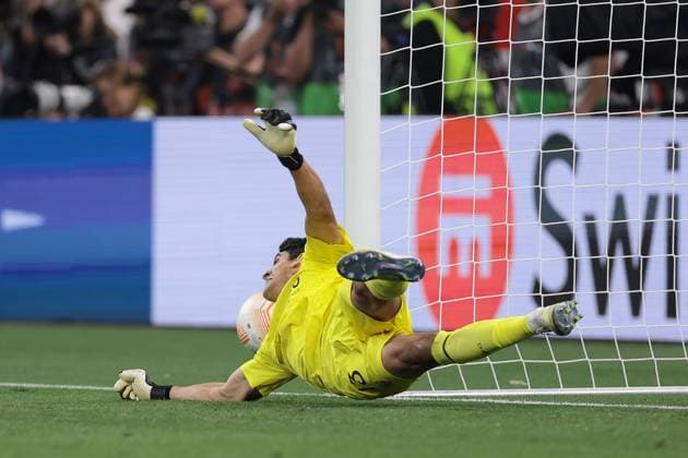 Budapest, Hungary, 31st May 2023. Yassine Bounou of Sevilla dives as Roger Ibanez of AS Roma™s penalty hits the goalpost and rebounds to safety during the UEFA Europa League match at Puskas Arena, Budapest. Picture credit should read: Jonathan Moscrop Sportimage EDITORIAL USE ONLY. No use with unauthorised audio, video, data, fixture lists, club league logos or live services. Online in-match use limited to 120 images, no video emulation. No use in betting, games or single club league player publications. SPI-2476-0074