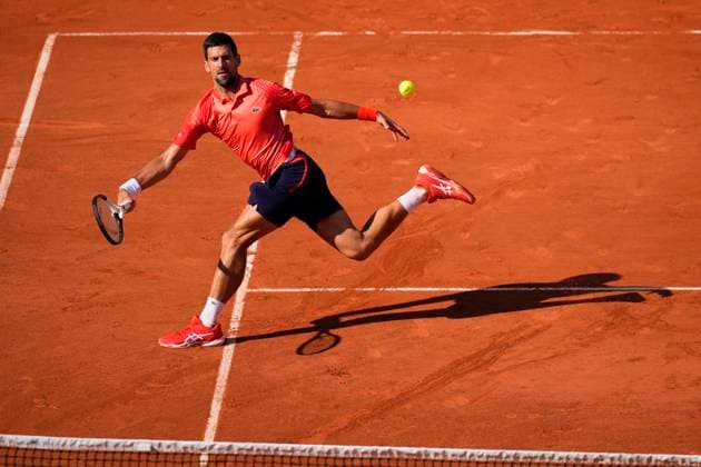 PARIS, FRANCE - JUNE 2: Novak Djokovic plays an acrobatic forehand volley during the 3nd round of Roland Garros 2023 match on June 02, 2023, at Roland Garros Stadium in Paris, France. (Photo by Glenn Gervot Icon Sportswire) TENNIS: JUN 02 French Open EDITORIAL USE ONLY Icon2306024014
