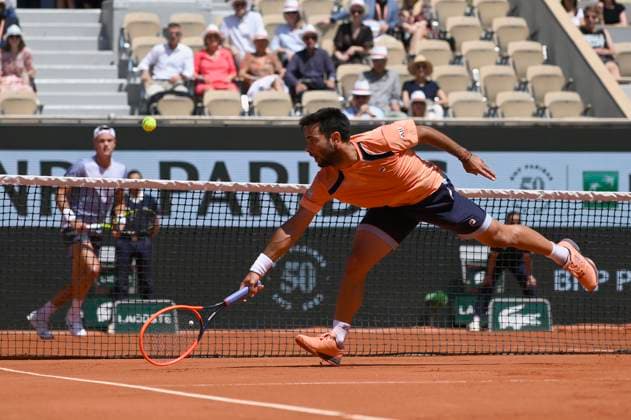 (230604) -- PARIS, June 4, 2023 -- Genaro Alberto Olivieri of Argentina hits a return during the men s singles third round match between Holger Rune of Denmark and Genaro Alberto Olivieri of Argentina at the French Open tennis tournament at Roland Garros in Paris, France, on June 3, 2023. (Photo by Xinhua) (SP)FRANCE-PARIS-TENNIS-ROLAND GARROS-FRENCH OPEN JulienxMattia 