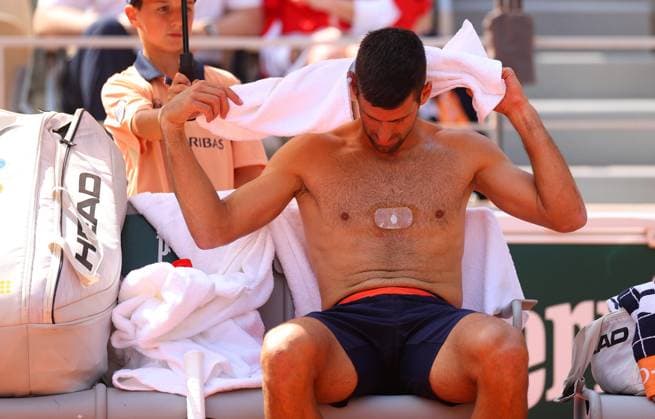 Mandatory Credit: Photo by Ella Ling Shutterstock (13949269cr) Novak Djokovic of Serbia gestures towards his team showing the magnet on his chest French Open Tennis, Day 10, Roland Garros, Paris, France - 06 June 2023 French Open Tennis, Day 10, Roland Garros, Paris, France - 06 June 2023  Copyright: xEllaxLing Shutterstockx 13949269cr