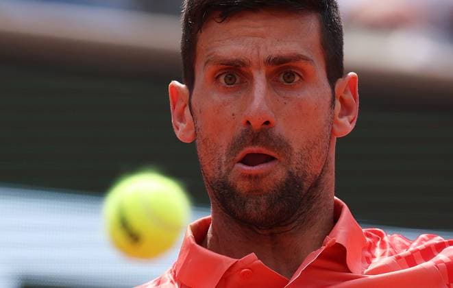 (230609) -- PARIS, June 9, 2023 -- Novak Djokovic of Serbia hits a return during the men s singles semifinals between Novak Djokovic of Serbia and Carlos Alcaraz of Spain at the French Open tennis tournament at Roland Garros in Paris, France, June 9, 2023. ) (SP)FRANCE-PARIS-TENNIS-ROLAND GARROS-FRENCH OPEN-MEN S SINGLES GaoxJing 