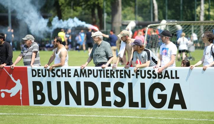 German Amputee Football League, Third Matchday at the Paul Hauenschild facility of the HSV SG Nord Ost Anpfiff Hoffenheim spectators watch the game behind an advertising hoarding of the German Amputee Football League Norderstedt Schleswig Holstein