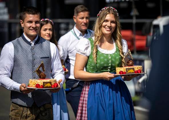 FORMULA 1 - GP of Austria 2023 SPIELBERG,AUSTRIA,30.JUN.23 - MOTORSPORTS, FORMULA 1 - Grand Prix of Austria, Red Bull Ring, practice and qualifying. Image shows hospitality persons with cakes.  GEPAxpictures xWolfgangxJannach