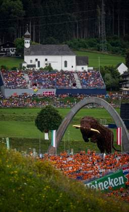FORMULA 1 - GP of Austria 2023 SPIELBERG,AUSTRIA,02.JUL.23 - MOTORSPORTS, FORMULA 1 - Grand Prix of Austria, Red Bull Ring, legends parade. Image shows the Bull and the church of Spielberg.  GEPAxpictures xWolfgangxJannach