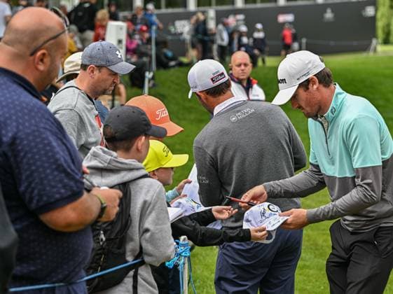 2nd July 2023; The Belfry, Sutton Coldfield, West Midlands, England: Betfred British Masters Golf, Day 4; Andrew Wilson and Edoardo Molinari sign autographs for fans by the 18th green  ActionPlus12526241 GodfreyxPitt