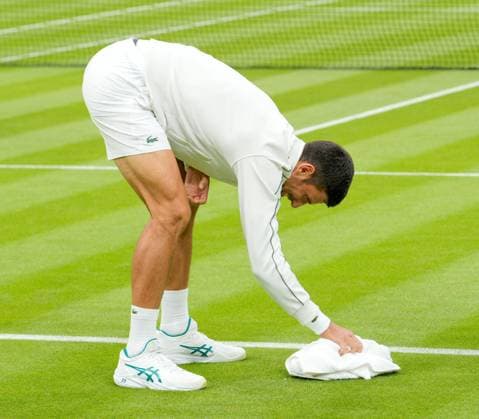 Mandatory Credit: Photo by Dave Shopland Shutterstock (13992815ak) Novak Djokovic towel drying the court during his first round match Wimbledon Tennis Championships, Day 1, The All England Lawn Tennis and Croquet Club, London, UK - 03 Jul 2023 Wimbledon Tennis Championships, Day 1, The All England Lawn Tennis and Croquet Club, London, UK - 03 Jul 2023  Copyright: xDavexShopland Shutterstockx 13992815ak