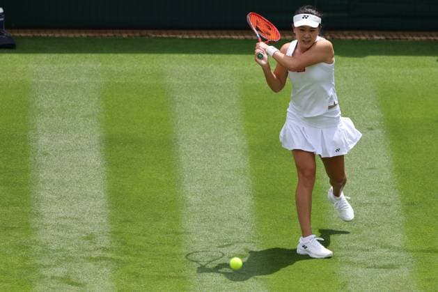 3rd July 2023; All England Lawn Tennis and Croquet Club, London, England: Wimbledon Tennis Tournament; Lin Zhu plays a backhand shot to Iga Swiatek in her womens singles match  ActionPlus12526777 ShaunxBrooks