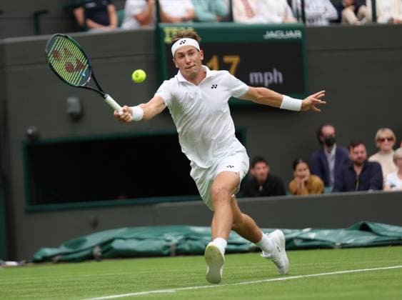 Norway s Casper Ruud plays a forehand in his first round match against France s Laurent Lokoli on day one of the 2023 Wimbledon championships in London on Monday, July 03, 2023.  LON2023070326 HUGOxPHILPOTT