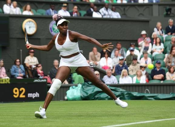 America s Venus Williams plays a forehand during her first round match against Ukraine s Elina Svitolina on day one of the 2023 Wimbledon championships in London on Monday, July 03, 2023.  LON2023070353 HUGOxPHILPOTT