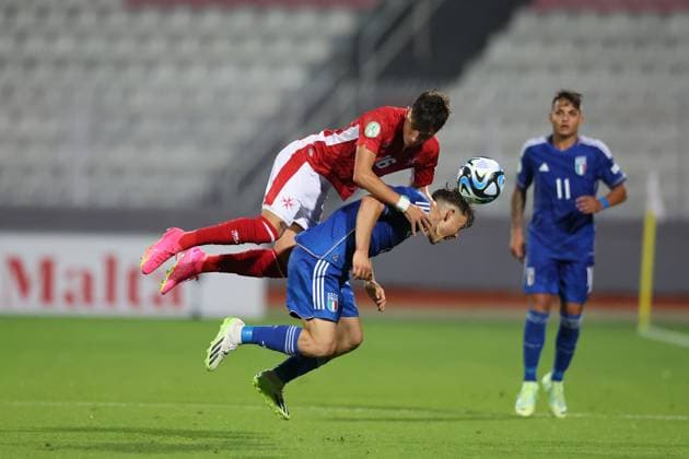 TA™QALI, MALTA JULY 3: Malta Under-19 soccer player Lucas Caruana (top) vies for the ball with Italy™s Lorenzo Amatucci (bottom) during the UEFA European Under-19 Championship 2022 23 Group A match between Malta and Italy at National Stadium on July 3, 2023, in Ta™Qali, Malta. UEFA European Under-19 Championship 2022 23 Final Tournament in Malta UEFA_U19_2023