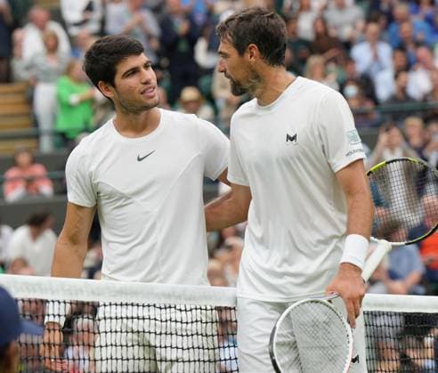 Tennis - 2023 Wimbledon Championships - Week One - Day Two - All England Lawn Tennis & Croquet Club, Wimbledon - Tuesday 4th July 2023 Carlos Alcaraz (ESP) v Jeremy Chardy (FRA) Carlos Alcaraz (ESP) at the net with Chardy after the match 