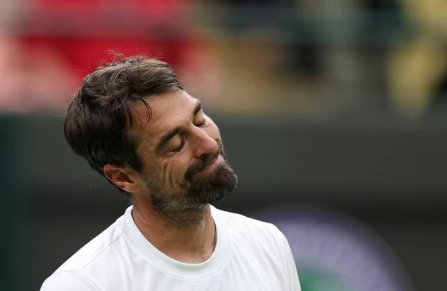 (230705) -- LONDON, July 5, 2023 -- Jeremy Chardy of France reacts during the men s singles first round match against Carlos Alcaraz of Spain at Wimbledon Tennis Championships in London, Britain, July 4, 2023. ) (SP)BRITAIN-LONDON-TENNIS-WIMBLEDON-DAY 2 LixYing 