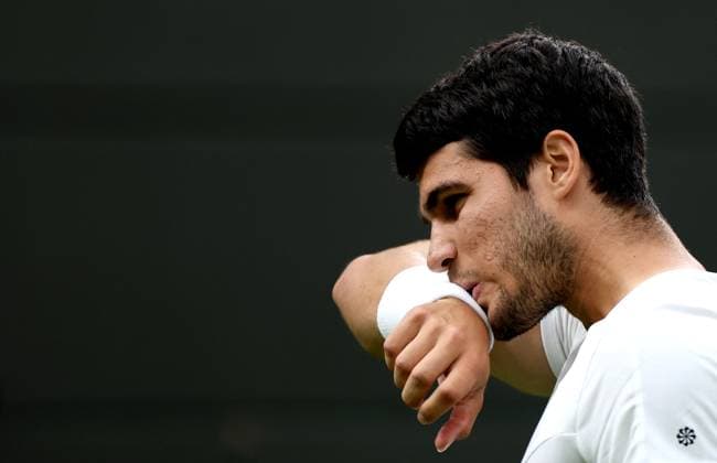 (230705) -- LONDON, July 5, 2023 -- Carlos Alcaraz of Spain reacts during the men s singles first round match against Jeremy Chardy of France at Wimbledon Tennis Championships in London, Britain, July 4, 2023. ) (SP)BRITAIN-LONDON-TENNIS-WIMBLEDON-DAY 2 LixYing 