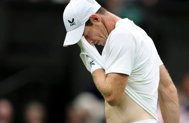 (230705) -- LONDON, July 5, 2023 -- Andy Murray of Britain wipes sweat during the men s singles first round match against Ryan Peniston of Britain at Wimbledon tennis Championships in London, Britain, on July 4, 2023. ) (SP)BRITAIN-LONDON-TENNIS-WIMBLEDON-DAY 2 HanxYan 