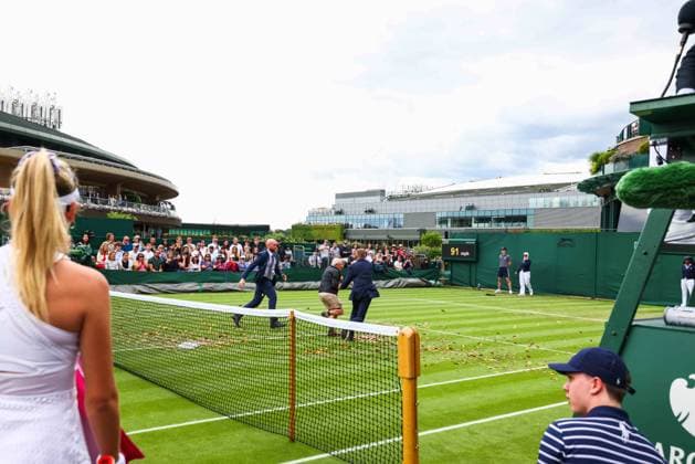 Mandatory Credit: Photo by Simon Dael Shutterstock (13995914co) Just Stop oil protesters disrupt the match between Katie Boulter and Daria Saville as Boulter looks on Wimbledon Tennis Championships, Day 3, The All England Lawn Tennis and Croquet Club, London, UK - 05 Jul 2023 Wimbledon Tennis Championships, Day 3, The All England Lawn Tennis and Croquet Club, London, UK - 05 Jul 2023  Copyright: xSimonxDael Shutterstockx 13995914co