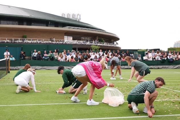 5th July 2023; All England Lawn Tennis and Croquet Club, London, England: Wimbledon Tennis Tournament; Katie Boulter and Daria Saville help the Wimbledon ground staff clean up the Just Oil protest glitter  ActionPlus12527317 ShaunxBrooks