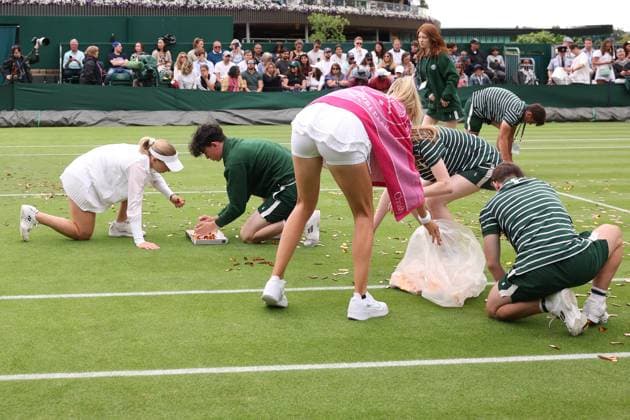5th July 2023; All England Lawn Tennis and Croquet Club, London, England: Wimbledon Tennis Tournament; Katie Boulter and Daria Saville help the Wimbledon ground staff clean up the Just Oil protest glitter  ActionPlus12527319 ShaunxBrooks