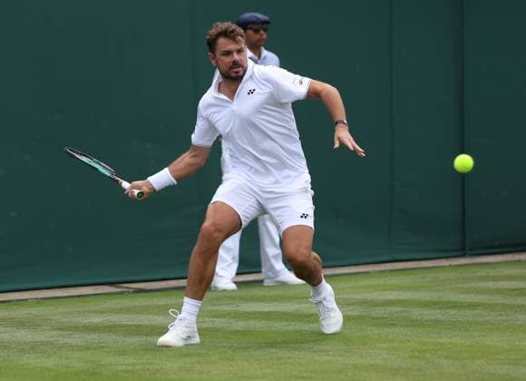 Switzerland s Stan Wawrinka plays a forehand in his second round match against Argentina s Tomas Martin Etcheverry on day four of the 2023 Wimbledon championships in London on Thursday, July 06, 2023.  LON2023070625 HUGOxPHILPOTT