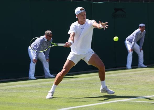 Denmark s Holger Rune plays a forehand in his second round match against Spain s Roberto Carballes Baena on day five of the 2023 Wimbledon championships in London on Friday, July 07, 2023.  LON2023070701 HUGOxPHILPOTT