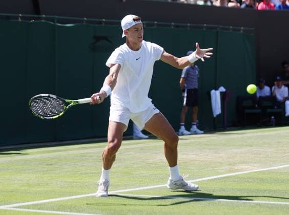 Denmark s Holger Rune plays a forehand in his second round match against Spain s Roberto Carballes Baena on day five of the 2023 Wimbledon championships in London on Friday, July 07, 2023.  LON2023070704 HUGOxPHILPOTT