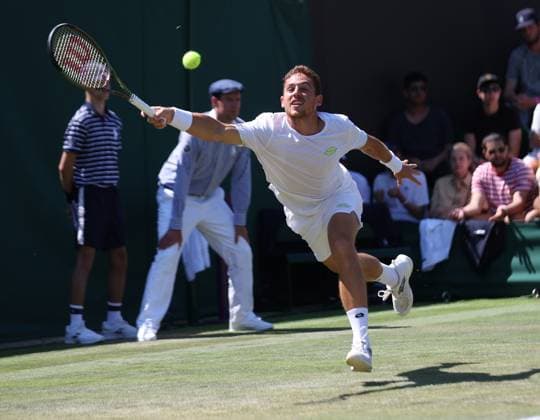 Spain s Roberto Carballes Baena plays a forehand in his second round match against Denmark s Holger Rune on day five of the 2023 Wimbledon championships in London on Friday, July 07, 2023.  LON2023070708 HUGOxPHILPOTT