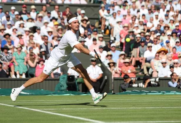 Greek Stefanos Tsitsipas plays a forehand in his second round match against Great Britain s Andy Murray on day five of the 2023 Wimbledon championships in London on Friday, July 07, 2023.  LON2023070779 HUGOxPHILPOTT
