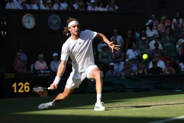 Greek Stefanos Tsitsipas plays a forehand in his second round match against Great Britain s Andy Murray on day five of the 2023 Wimbledon championships in London on Friday, July 07, 2023.  LON2023070785 HUGOxPHILPOTT