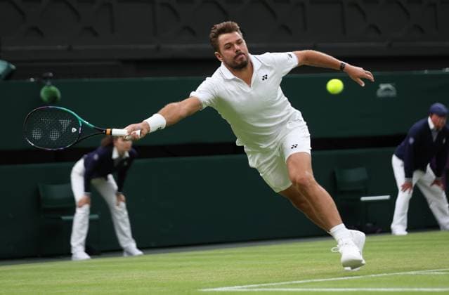 Swiss Stan Wawrinka plays a forehand in his third round match against Serbian Novak Djokovic on day five of the 2023 Wimbledon championships in London on Friday, July 07, 2023.  LON2023070786 HUGOxPHILPOTT