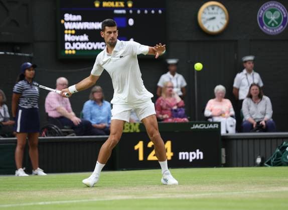Serbian Novak Djokovic plays a forehand in his third round match against Swiss Stan Wawrinka on day five of the 2023 Wimbledon championships in London on Friday, July 07, 2023.  LON2023070788 HUGOxPHILPOTT