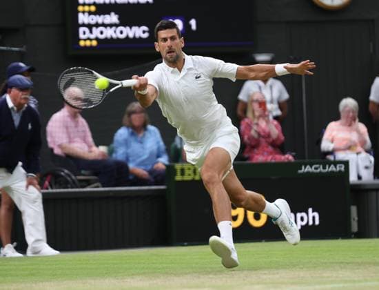 Serbian Novak Djokovic plays a forehand in his third round match against Swiss Stan Wawrinka on day five of the 2023 Wimbledon championships in London on Friday, July 07, 2023.  LON2023070794 HUGOxPHILPOTT