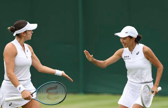 (230708) -- LONDON, July 8, 2023 -- Zhang Shuai (R) Caroline Dolehide celebrate scoring during the women s doubles second round match between Hozumi Eri of Japan Rebeka Masarova of Spain and Zhang Shuai of China Caroline Dolehide of the United States at Wimbledon Tennis Championships in London, Britain, July 8, 2023. ) (SP)BRITAIN-LONDON-TENNIS-WIMBLEDON-DAY 6 HanxYan 