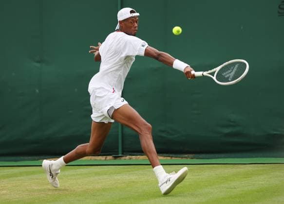 American Christopher Eubanks plays a backhand in his match against Australian Christopher O Connell on day six of the 2023 Wimbledon championships in London on Saturday, July 08, 2023.  LON2023070851 HUGOxPHILPOTT