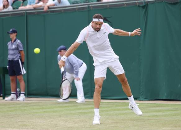 Bulgarian Gregor Dimitrov plays a backhand in his match against American Frances Tiafoe on day six of the 2023 Wimbledon championships in London on Saturday, July 08, 2023.  LON2023070855 HUGOxPHILPOTT