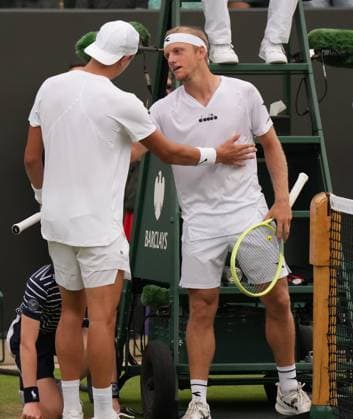 Tennis - 2023 Wimbledon Championships - Week One - Day Six - All England lawn Tennis & Racquet Club, Wimbledon - Saturday 8th Mens Singles- Leandro Davidovich Fokina (ESP) v Holger Rune (DEN) Holger Rune consoles Davidovich Fokina after the match 