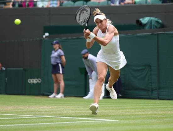 Ukraine s Lesia Tsurenko plays a backhand in her match against American Jessica Pegula on day seven of the 2023 Wimbledon championships in London on Sunday, July 9, 2023.  LON20230709023 HUGOxPHILPOTT