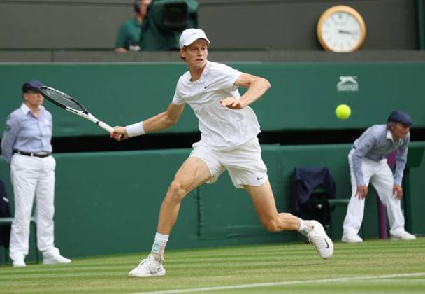 Italy s Jannik Sinner plays a forehand in his match against Columbia s Daniel Elah Galan on day seven of the 2023 Wimbledon championships in London on Sunday, July 9, 2023.  LON2023070903 HUGOxPHILPOTT