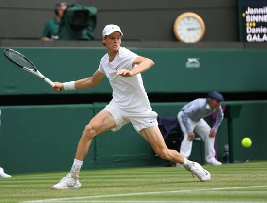 Italy s Jannik Sinner plays a forehand in his match against Columbia s Daniel Elah Galan on day seven of the 2023 Wimbledon championships in London on Sunday, July 9, 2023.  LON2023070906 HUGOxPHILPOTT