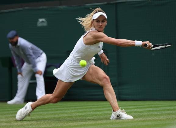 Ukraine s Lesia Tsurenko plays a backhand in her match against American Jessica Pegula on day seven of the 2023 Wimbledon championships in London on Sunday, July 9, 2023.  LON2023070920 HUGOxPHILPOTT